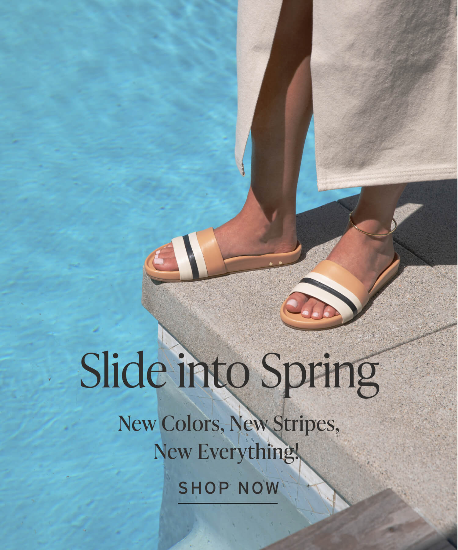 Woman wearing Gallito Stripe leather slide sandals in eggshell/beach with dress by the pool with caption "Slide into Spring. New Colors, New Stripes, New Everything!" and Shop Now button.