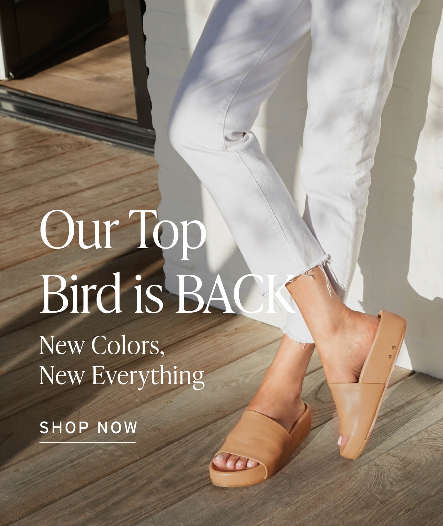 Woman wearing Pelican leather slide sandal in honey with white pants. Caption “Our top bird is back. new. llosa, new everything. Shop our best selling Pelican”