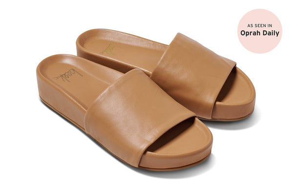 Pelican honey leather slide sandal in honey - product angle shot with "As seen in Oprah Daily" badge