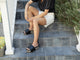 Woman wearing Albatross Woven leather platform sandal in eggshell/black with white shorts on steps