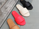 Group shot of Baza leather slide sandals in honey, cherry, eggshell, black