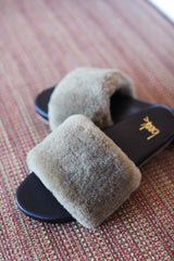 Baza Shearling slide sandal in bronze/black - product shot on rug