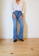 Woman wearing Catbird leather boot in black with jeans and white shirt