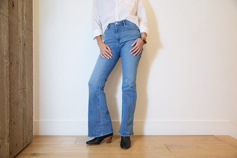 Woman wearing Catbird leather boot in black with jeans and white shirt