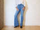 Woman wearing Catbird leather boot in black with jeans and white shirt