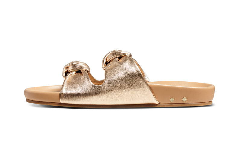 Coquette leather slide sandals in gold/beach - product side shot