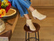 Woman wearing Eagle suede heeled boot in stone with jeans and sweater