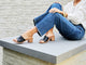 Woman wearing Emerald block heel leather sandal in black with jeans