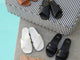 Fernbird leather slide sandals in black and vanilla with Sugarbird leather slide sandals in tan, black, and beach by the pool