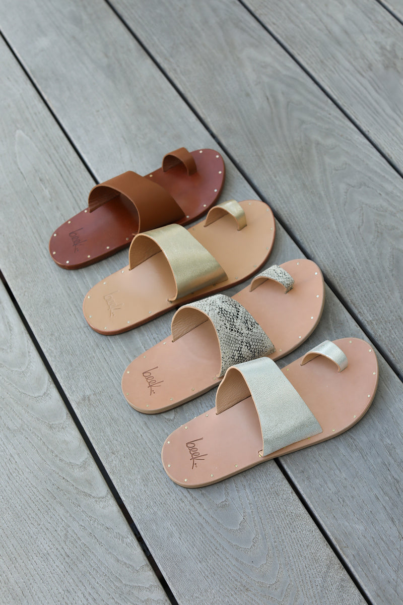 Group shot of Finch leather toe-ring sandals in tan, platinum/honey, snake/beach, and silver/beach