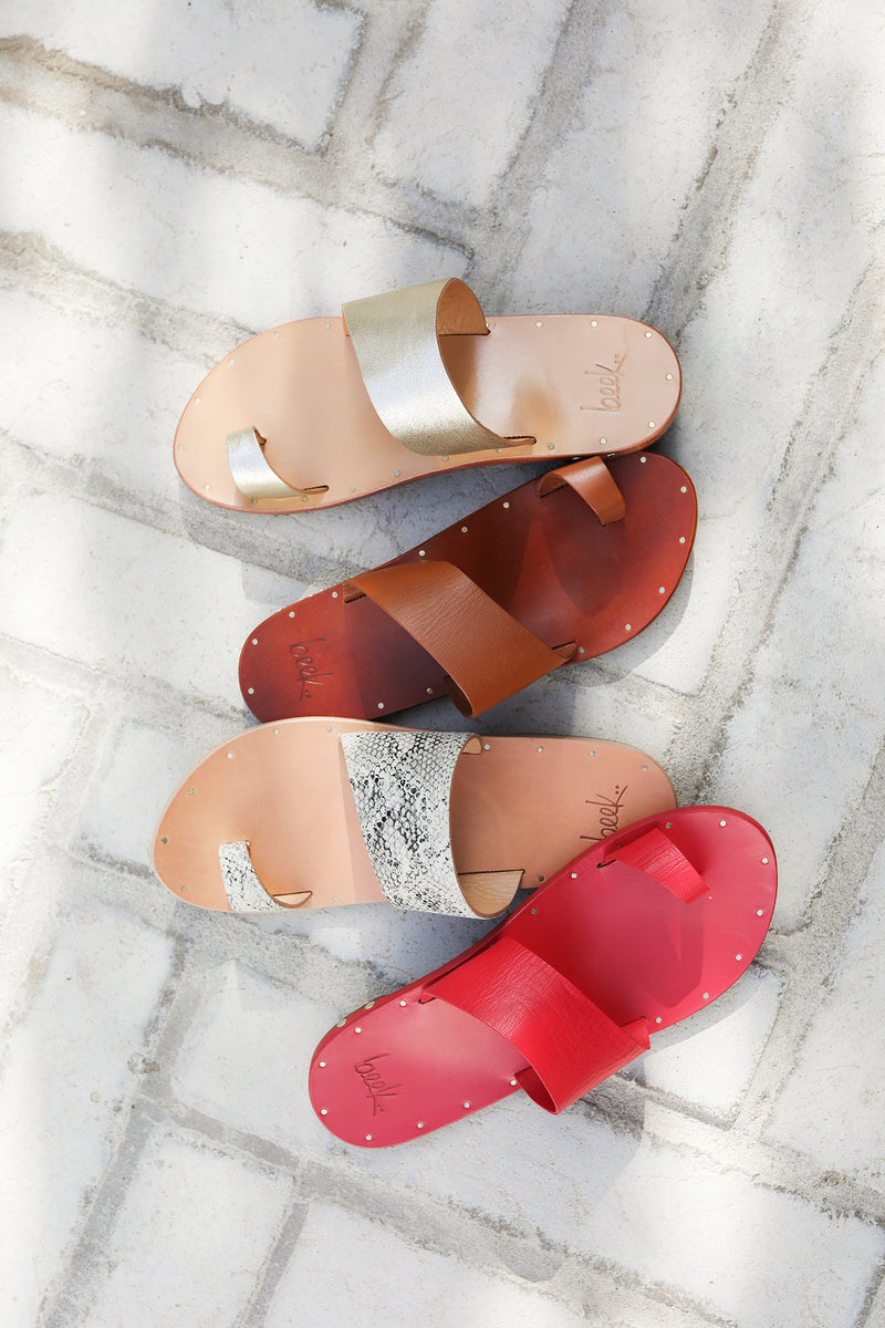 Group shot of Finch leather toe-ring sandals in tan, platinum/honey, and snake/beach