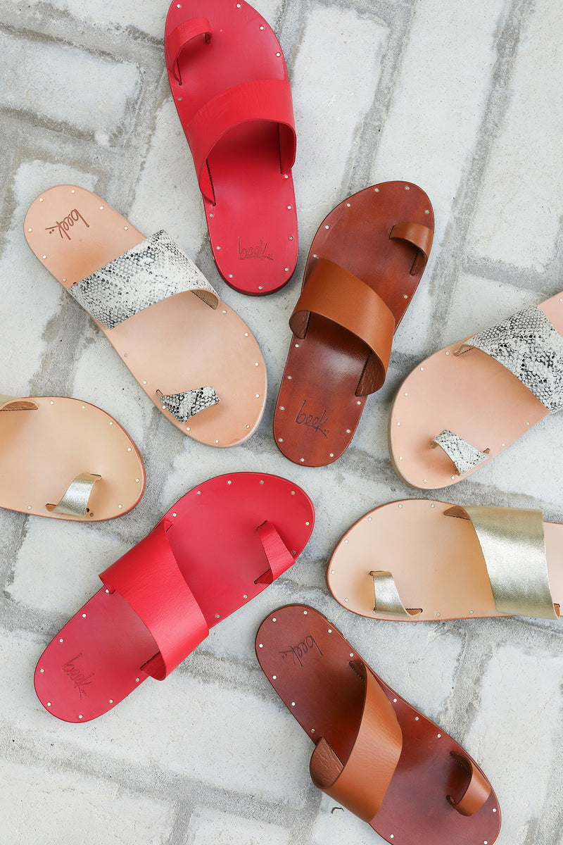 Group shot of Finch leather toe-ring sandals in tan, platinum/honey, and snake/beach