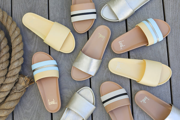 Group shot of Gallito leather slide sandals in glow, platinum/beach, platinum with Gallito Stripe sandals in eggshell/beach and sky/beach