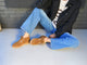 Woman wearing Goose suede shearling boot in chestnut with jeans and sweater and jacket