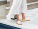 Woman wearing Hen leather platform criss-cross sandals in eggshell with white dress