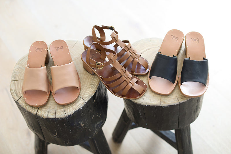 Group shot of Heron leather ankle strap block heel sandal in tan with Emerald leather block heel sandals in honey and black.