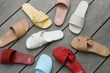 Group shot of Honeybird leather slide sandals in sky, red, beach, and blush with Fernbird leather slide sandals in vanilla and Sweetbird leather slide sandals in lipstick and glow.