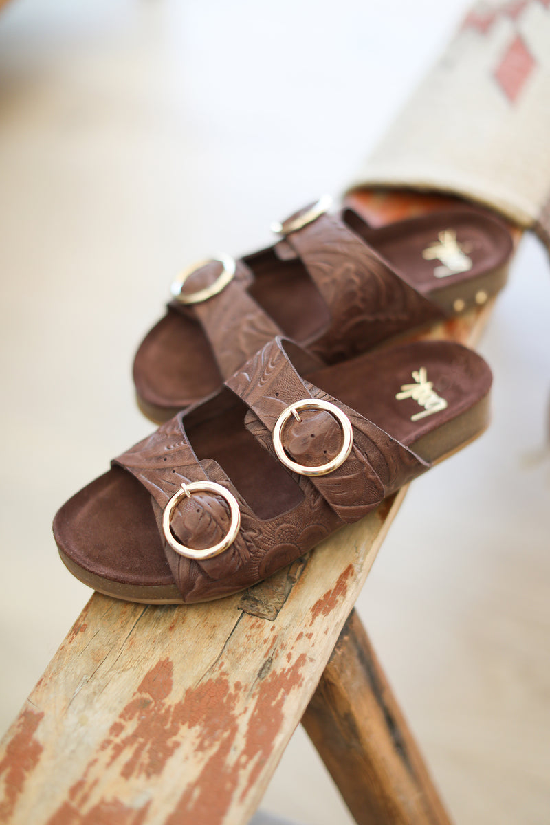 Jery embossed leather slide sandal n chocolate - product angle shot on wooden beam