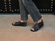 Woman wearing Loon leather sandals in black with black jeans