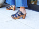 Woman wearing Magpie leather heeled clogs in black with jeans