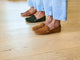 Women wearing Moorhen suede loafers in caramel, moss, and tan leather.