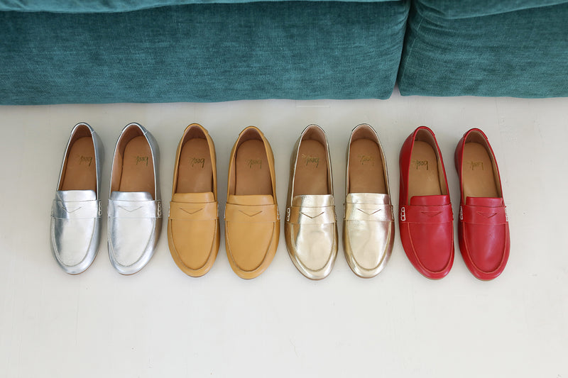 Group shot of Moorhen leather loafers in silver, honey, gold, and lipstick.