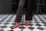 Woman wearing Moorhen leather loafers in lipstick with plaid pants