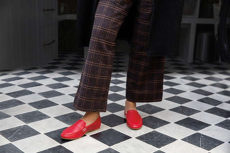 Woman wearing Moorhen leather loafers in lipstick with plaid pants