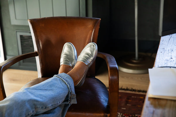 Woman wearing Moorhen leather loafers in silver with jeans