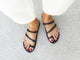 Woman wearing Nene leather slide sandal in black with white pants