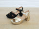 Group shot of Partybird platform heeled sandals in black and gold