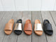 Group shot of Pelican leather slide sandals in honey, bronze/black, tan, platinum/beach, and black.