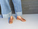 Woman wearing Group shot of Pepper leather loafer in cognac with jeans.