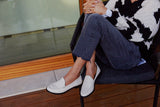 Woman wearing Pepper leather loafer in eggshell with jeans and sweater