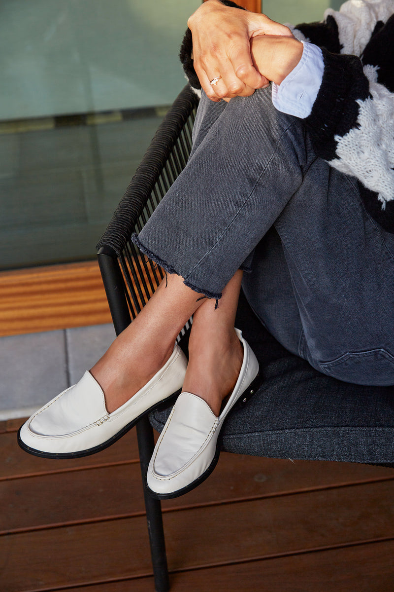 Woman wearing Pepper leather loafer in eggshell with jeans and sweater