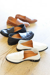 Group shot of Pepper leather loafer in eggshell, cognac, and black