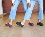 Women wearing Prinia suede platform sandal in plum and Petrel suede platform heel in moss