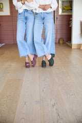 Women wearing Prinia suede platform sandal in plum and Petrel suede platform heel in moss