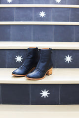 Pheasant leather boots in black/tan - angle shot on steps