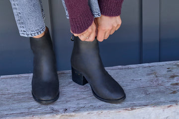 Woman wearing Pheasant leather boots in black with jeans and sweater