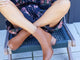 Woman wearing Pheasant leather boots in cognac with floral outfit and hat