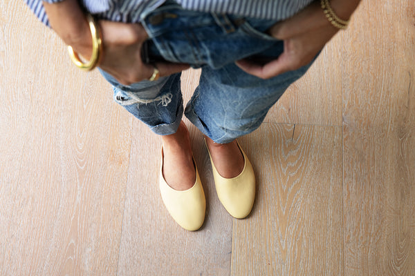 Woman wearing Phoebe leather ballet mule in glow with jeans