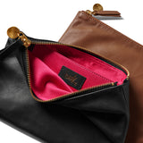 Group shot of leather pouches in black unzipped to show pink lining and beek logo and tan.