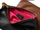 Group shot of leather pouches in black unzipped to show pink lining and beek logo and tan.