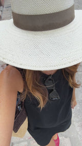 Woman walking wearing Swiftlet ballet slipper in lipstick with black dress and hat. ClosedCaption