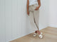 Woman wearing Prinia leather platform heel sandal in eggshell with light gray jeans