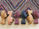 Group shot of Prinia suede platform heel sandal in caramel suede, tan leather, plum suede, and black leather