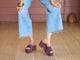 Woman wearing Prinia suede platform heel sandal in plum with jeans and white blouse