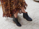 Woman wearing Quail leather boot in black with floral dress.