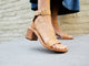 Woman wearing Sapphire block heel sandal in honey with denim dress